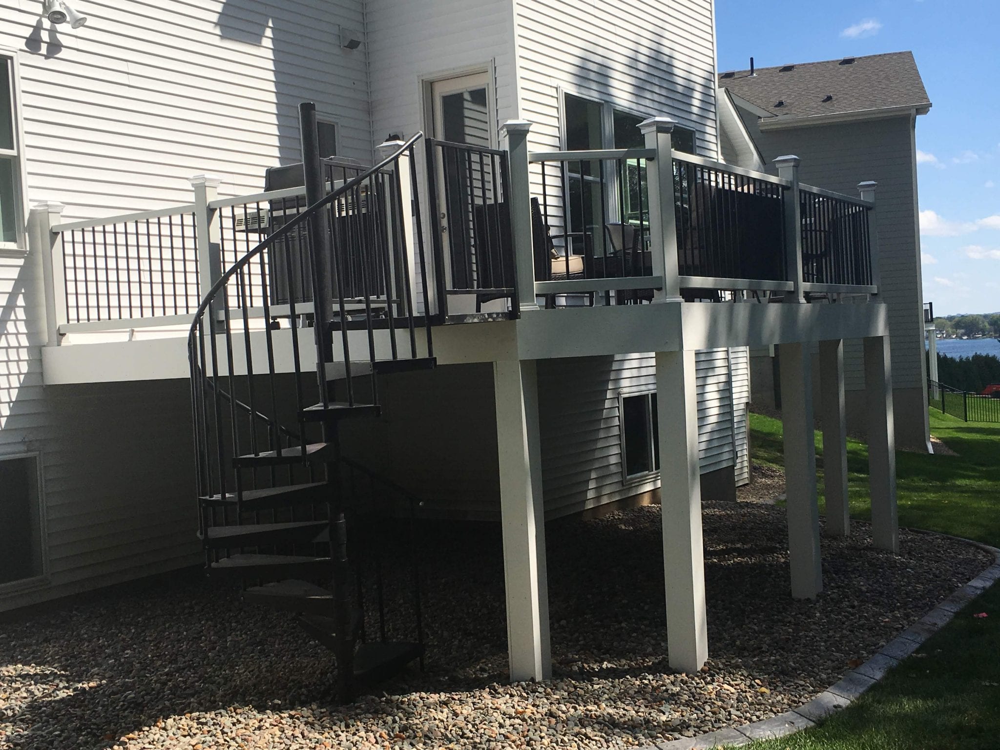 Composite deck with white railings and patio furniture