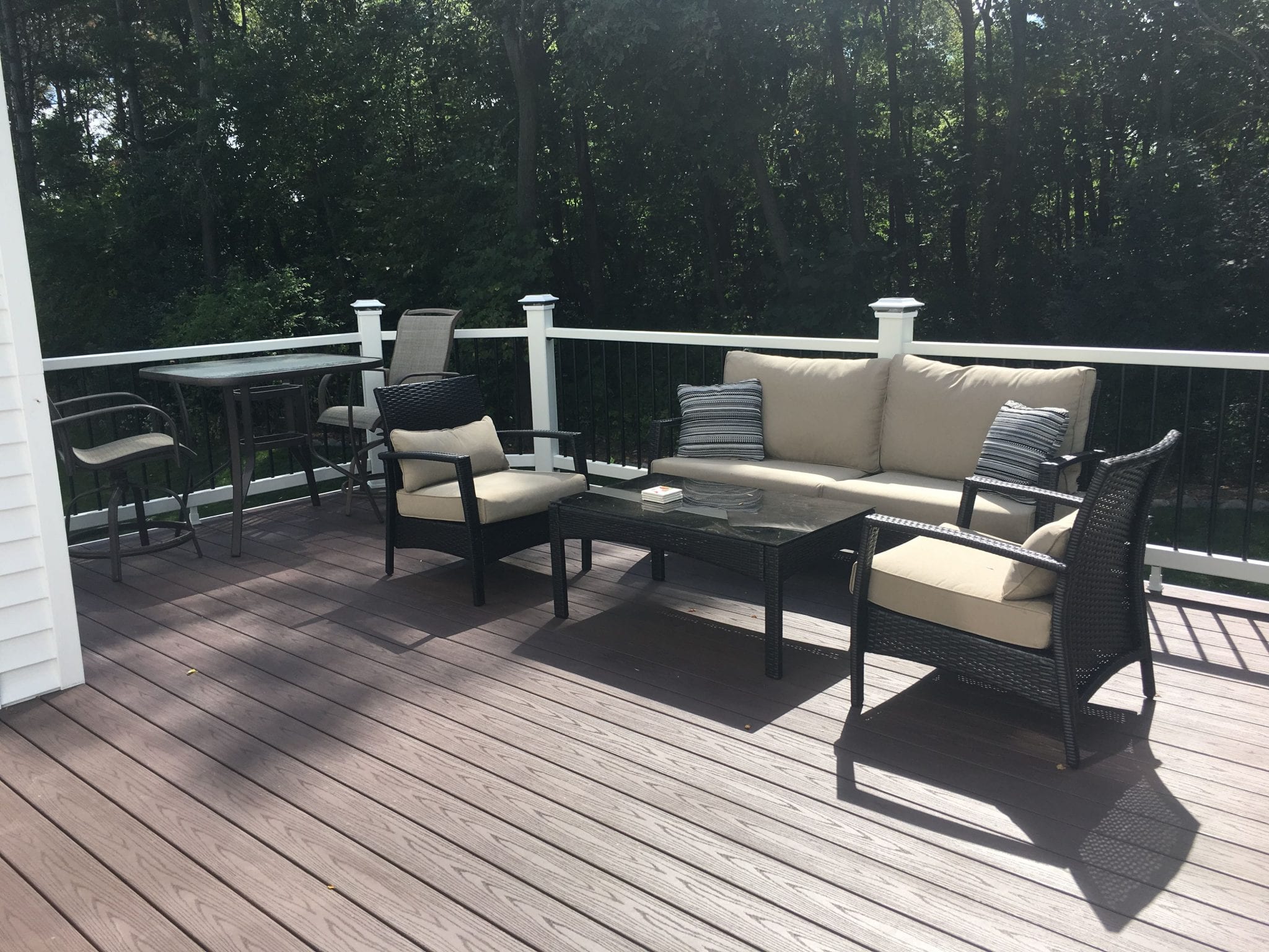 Composite deck with white railings and patio furniture