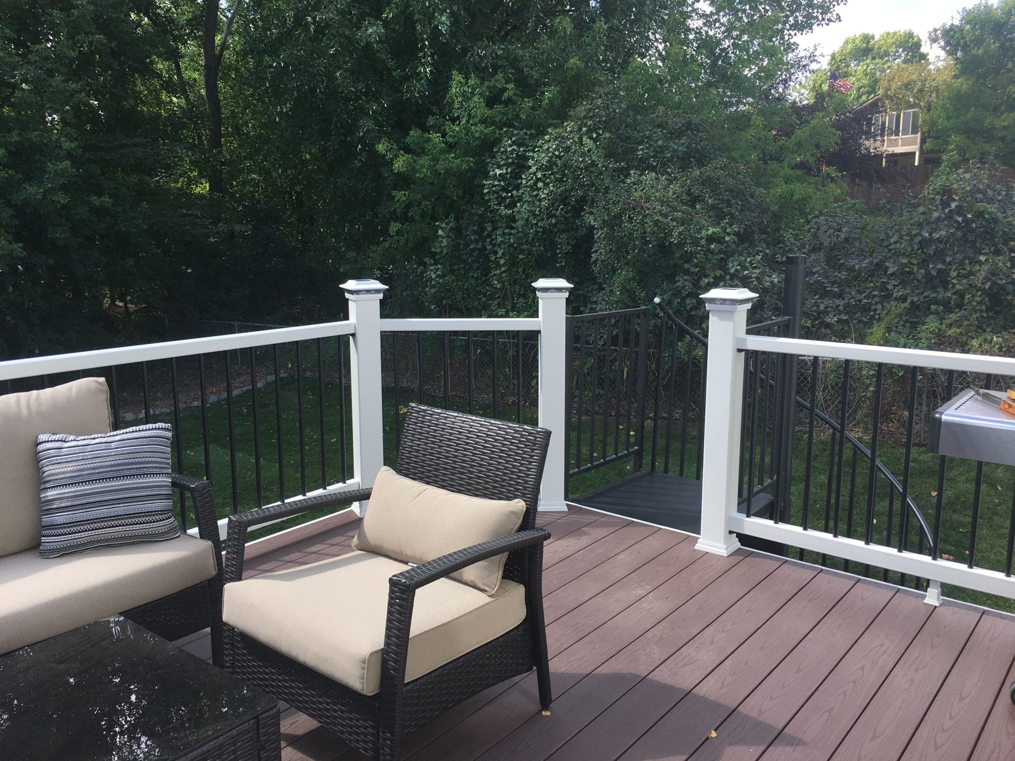 Composite deck with white railings and patio furniture