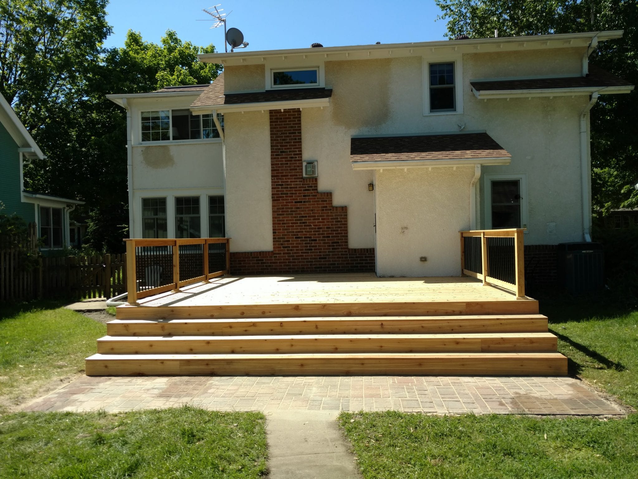 new unstained deck with black railing posts