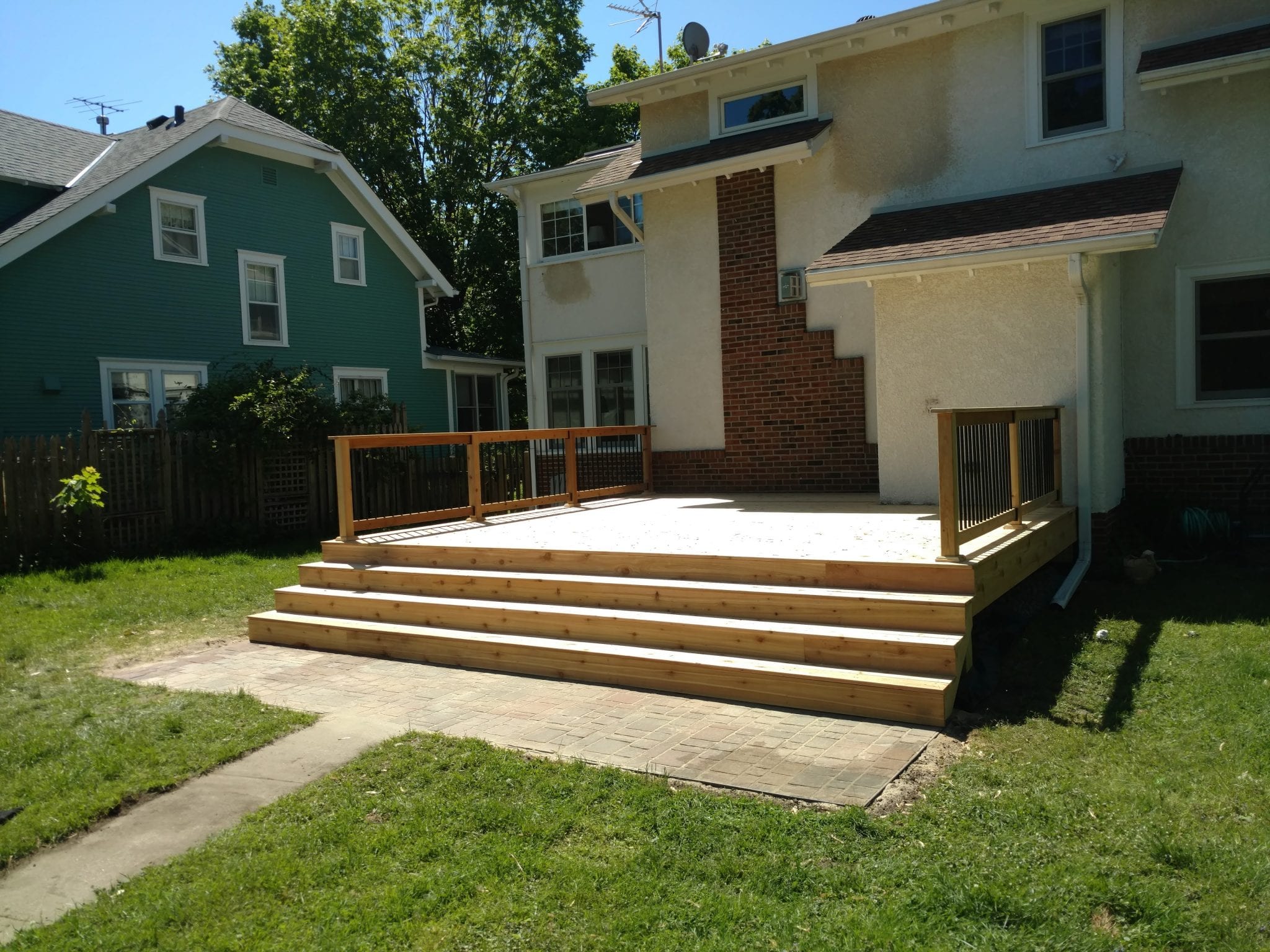 new unstained deck with black railing posts