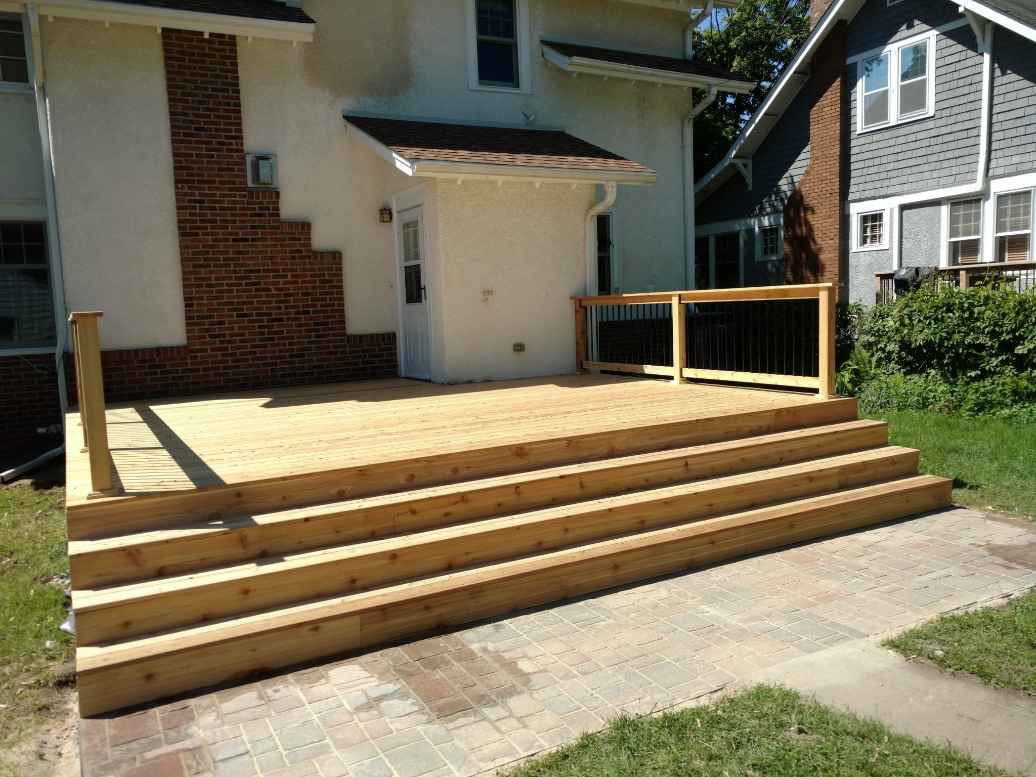 new unstained deck with black railing posts