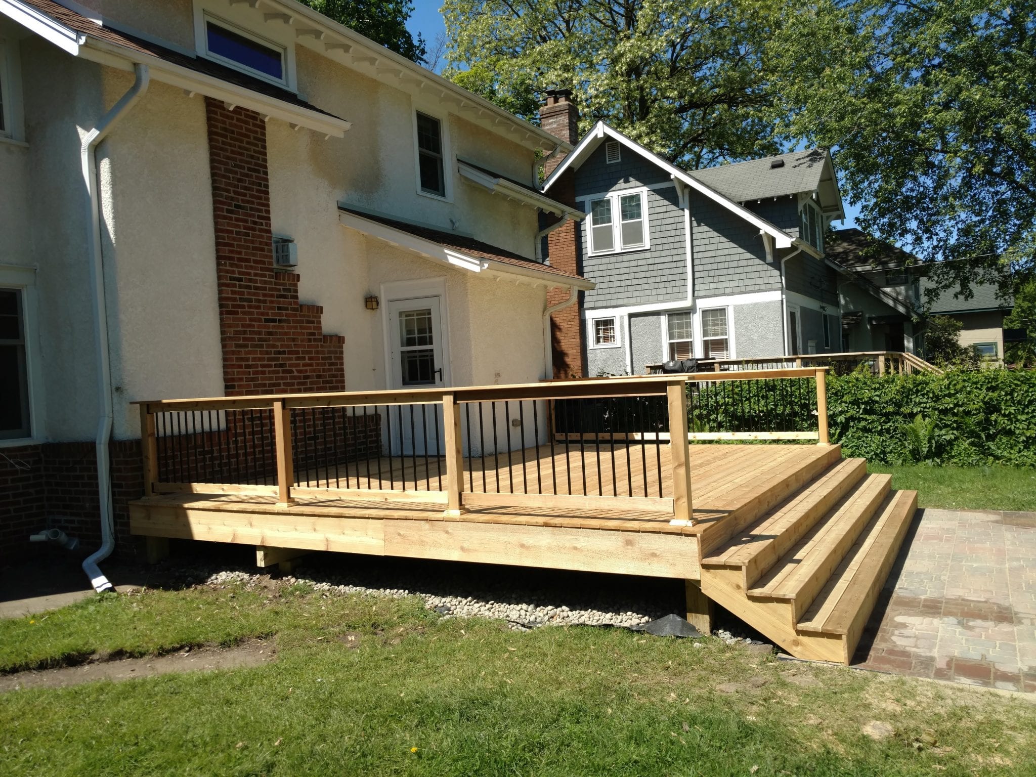new unstained deck with black railing posts