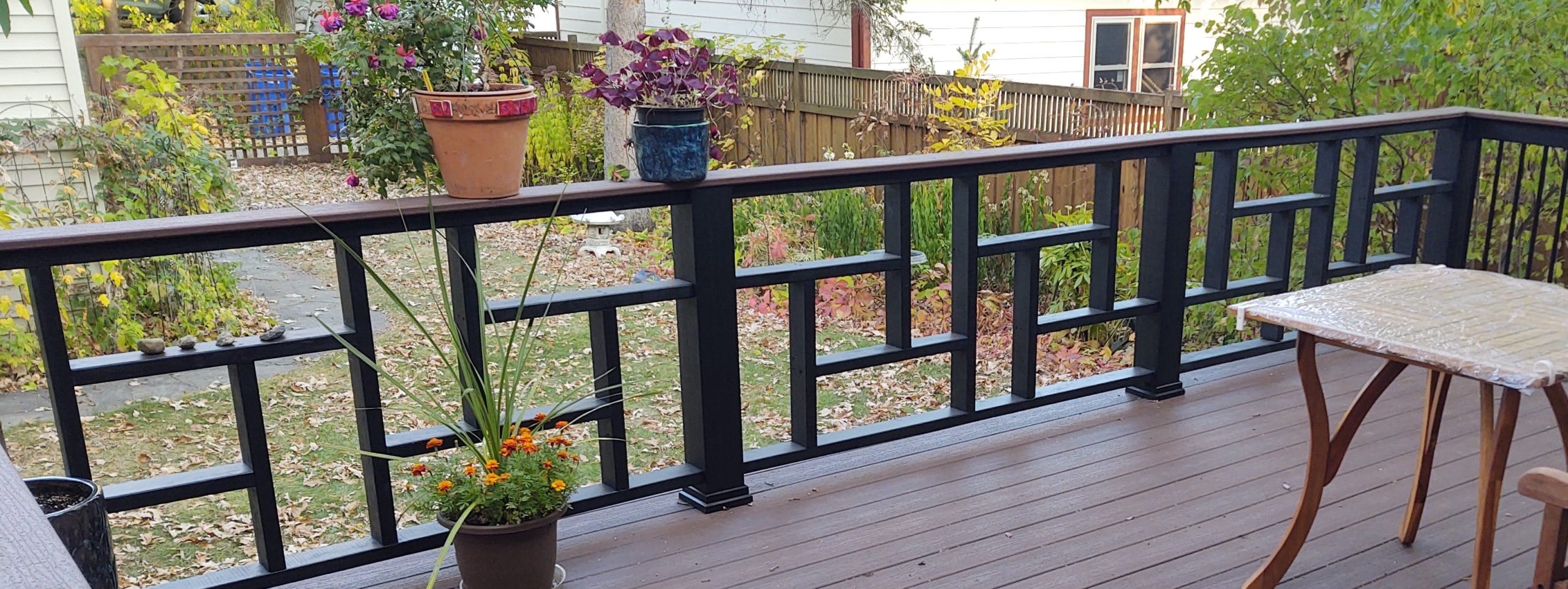 brown composite deck surface with black geometric railings