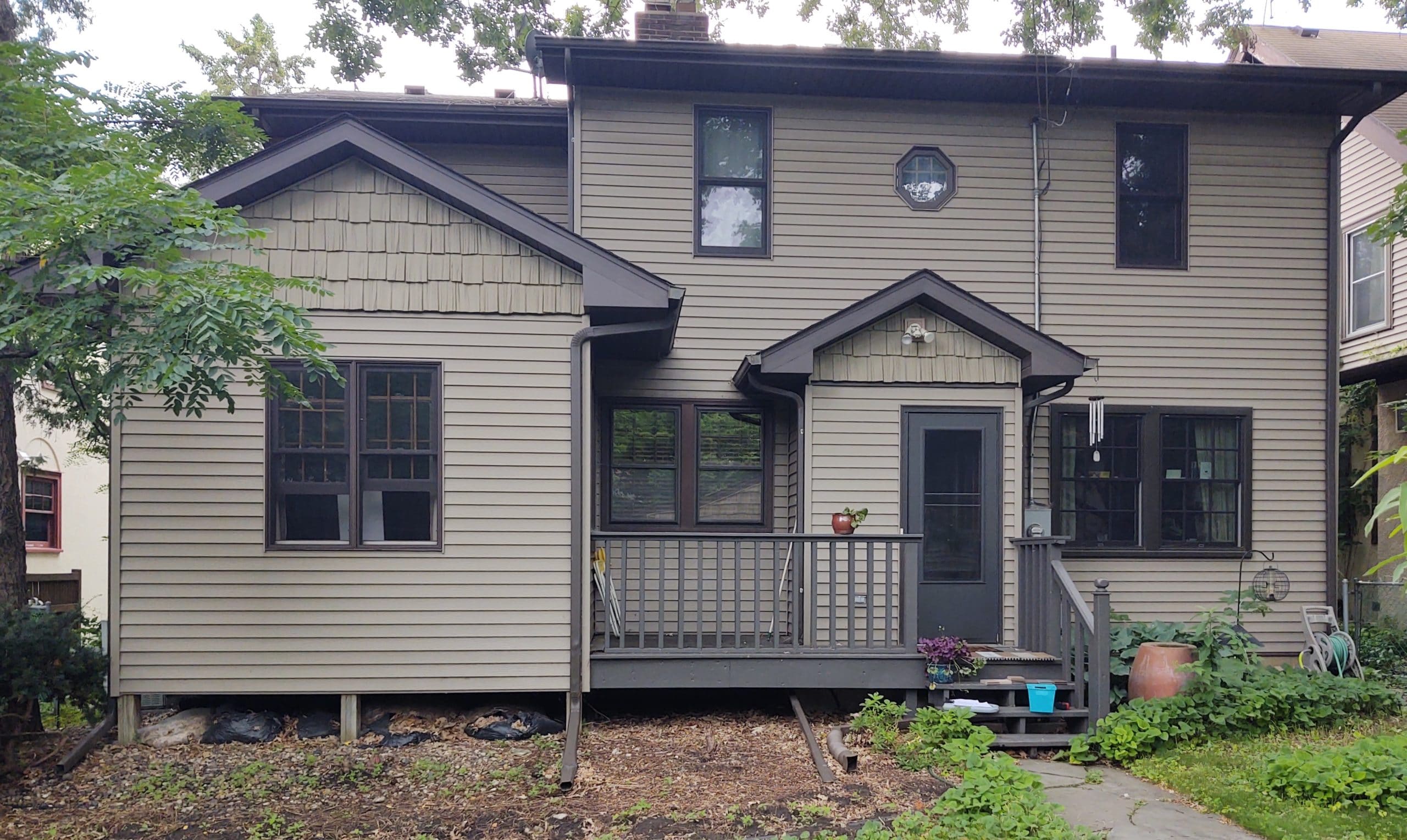 backside of a dark beige house with brown trim